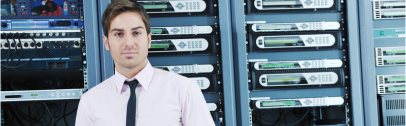 man in a tie standing in front of a server